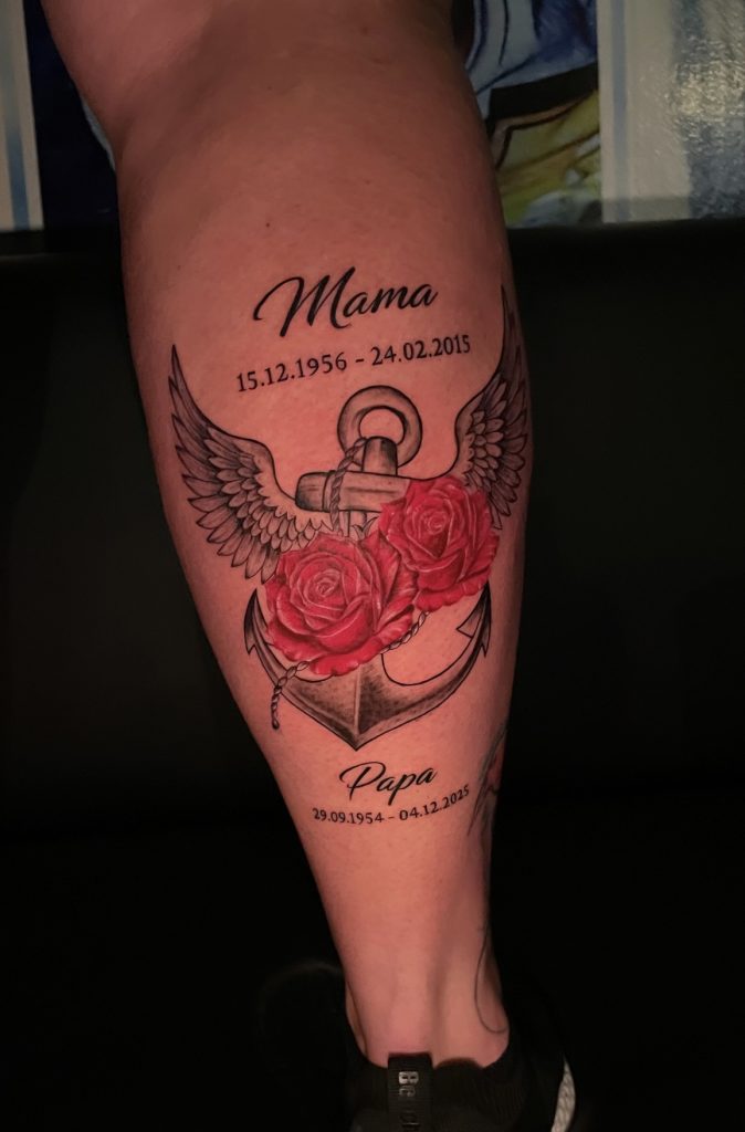 Memorial tattoo on lower leg with winged anchor and red roses, Hurghada tattoo studio”