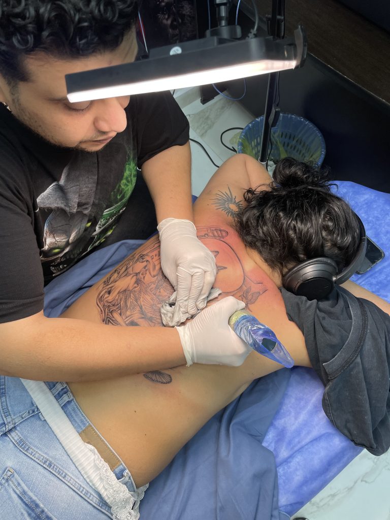 Egyptian Bastet cat goddess back tattoo in black and grey with hieroglyphics and cats — Hurghada, Egypt” “